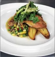  ?? PHOTO COURTESY OF DINOÍS BACKSTAGE AND THE CELEBRITY ROOM ?? Arugula salad and julienned apples top this organic chicken with summer succotash.