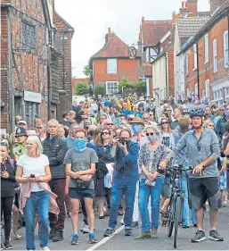  ??  ?? Crowds gather in the East Sussex village of Ditchling.