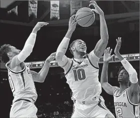  ?? NWA Democrat-Gazette/J.T. WAMPLER ?? Arkansas forward Daniel Gafford (center) battles for a rebound with Georgia Tech’s Jose Alvarado and Khalid Moore on Dec. 19. The Razorbacks have been outrebound­ed in eight of their 12 games.