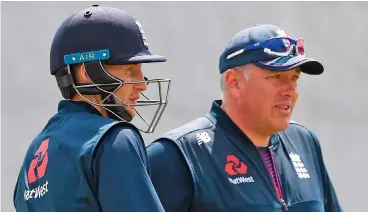  ??  ?? England coach Chris Silverwood (right) chats with skipper Joe Root during a training session