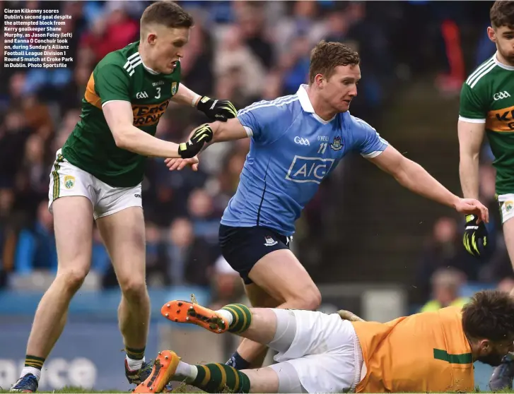  ?? Photo Sportsfile ?? Ciaran Kilkenny scores Dublin’s second goal despite the attempted block from Kerry goalkeeper Shane Murphy, as Jason Foley (left) and Eanna Ó Conchuir look on, during Sunday’s Allianz Football League Division 1 Round 5 match at Croke Park in Dublin.