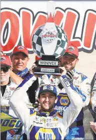  ?? Brian Lawdermilk / Getty Images ?? Chase Elliott celebrates with the trophy after winning the Monster Energy NASCAR Cup Series Go Bowling at The Glen Sunday in Watkins Glen, N.Y.