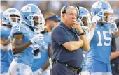  ?? GRANT HALVERSON/TNS FILE ?? North Carolina and other universiti­es with similar plans of returning students to campus are shoulderin­g a great responsibi­lity to maintain a safe environmen­t for athletes, such as the players under coach Mack Brown, above.