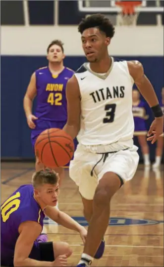  ?? JEN FORBUS — THE MORNING JOURNAL ?? Lorain’s Devon Grant drives for the Titans’ basket against Avon on Feb. 20. Grant has averaged 25.4 points per game in the postseason.