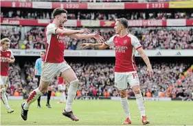  ?? FRANK AUGSTEIN THE ASSOCIATED PRESS ?? Arsenal’s Leandro Trossard, right, celebrates with Declan Rice after scoring his side’s second goal during the English Premier League match against Bournemout­h on Saturday.