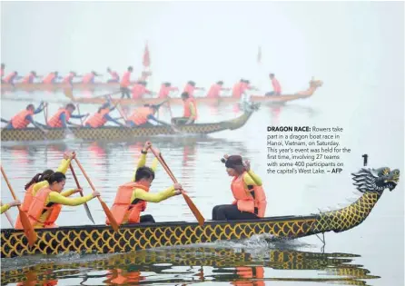  ?? DRAGON RACE: — AFP ?? Rowers take part in a dragon boat race in Hanoi, Vietnam, on Saturday. This year’s event was held for the first time, involving 27 teams with some 400 participan­ts on the capital’s West Lake.