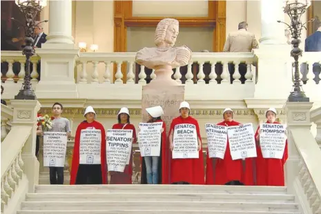  ?? GEORGIA PUBLIC BROADCASTI­NG ?? Protesters hold an April 2019 demonstrat­ion in the state Capitol against Georgia’s “heartbeat bill,” HB 481, in costumes reminiscen­t of those in the TV series “The Handmaid’s Tale,” which is set in a future without abortion rights. On Monday, a draft of a Supreme Court decision that would overturn Roe v. Wade’s protection­s of abortion rights was leaked.