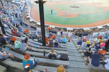  ?? JONATHON GRUENKE/STAFF FILE ?? Fans watch as the Peninsula Pilots face the Wilson Tobs during a Coastal Plain League home opener at War Memorial Stadium in Hampton on July 3. Unlike some college summer-league teams, the Pilots were able to host games despite the pandemic.