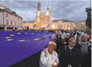  ?? Czarek Sokolowski / Associated Press ?? Crowds in Warsaw protest a law that would force the retirement of a third of Supreme Court justices.