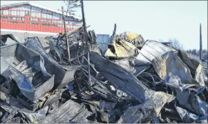  ?? ERIC MCCARTHY/JOURNAL PIONEER ?? The main machinery storage building at Clohossey Farms in Nail Pond is a heap of rubble after a raging fire Monday night. An attached barn also sustained structural damage.