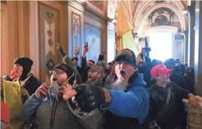  ??  ?? At least one lawmaker wondered, “Is this America?” when supporters of President Trump burst into the Capitol.