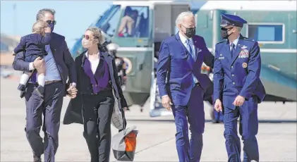  ?? Patrick Semansky The Associated Press ?? President Joe Biden walks with his son Hunter Biden, Hunter’s wife, Melissa Cohen, and their son Beau on Friday before boarding Air Force One at Andrews Air Force Base, Md. The president is spending the weekend at his home in Delaware.