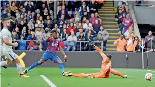  ?? Reuters ?? Crystal Palace’s Wilfried Zaha scores a goal against Chelsea in the Premier League match. —