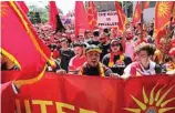  ??  ?? DETERMINED: Macedonian Australian­s march in Melbourne’s CBD yesterday.