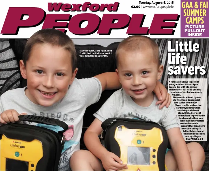  ??  ?? Six-year-old MJ, and Ryan, aged 2, with their defibrilla­tors which were delivered on Saturday.