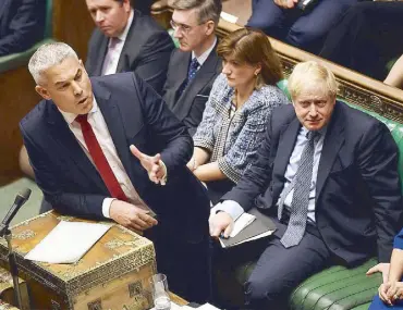  ?? REUTERS ?? British Prime Minister Boris Johnson listens to Brexit Secretary Stephen Barclay, ahead of a vote on the prime minister’s renegotiat­ed Brexit deal at the House of Commons in London on Saturday.