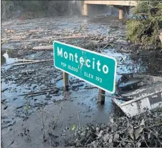  ?? Michael Owen Baker For The Times ?? MUD SURROUNDS a sign off U.S. Highway 101 in Montecito on Sunday. Officials are unsure when the freeway will be reopened.