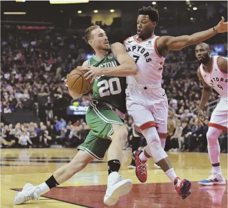  ?? APPHOTO ?? ROAD BLOCK: Gordon Hayward tries to drive to the hoop against the tight defense of the Raptors’ Kyle Lowry during the Celtics’ 113-101 loss last night in Toronto.