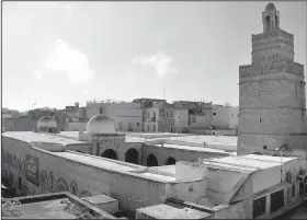  ??  ?? The sun shines down on the central mosque inside the medina in Sfax, Tunisia. City officials are seeking UNESCO protection status for the ancient medina.