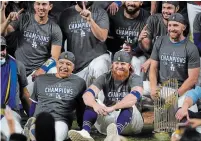  ?? ERIC GAY THE ASSOCIATED PRESS FILE PHOTO ?? Los Angeles third baseman Justin Turner, bottom right, was widely criticized for returning to the field to join the Dodgers World Series celebratio­ns after testing positive for COVID-19.