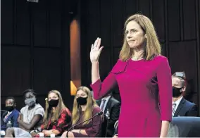  ?? NEW YORK TIMES VIA THE ASSOCIATED PRESS] ?? Supreme Court nominee Amy Coney Barrett is sworn in Monday during her Senate Judiciary Committee confirmati­on hearing on Capitol Hill in Washington. [ERIN SCHAFF/ THE