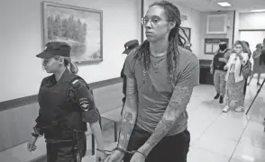  ?? ALEXANDER ZEMLIANICH­ENKO/AP FILE ?? WNBA star and Olympic gold medalist Brittney Griner is escorted from a courtroom in Khimki, Russia, on Aug. 4.