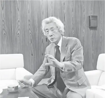  ??  ?? Junichiro Koizumi, the former prime minister of Japan, speaks in an interview in Tokyo and (above) bags of nuclear waste are stored in the Japanese town of Naraha on Jan 25. Reconstruc­tion and cleanup of the areas affected by the Mar 11, 2011, tsunami and Fukushima Daiichi nuclear accident continue almost eight years later. — WP-Bloomberg photos