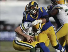  ?? MARCIO JOSE SANCHEZ - THE ASSOCIATED PRESS ?? Los Angeles Rams defensive tackle Aaron Donald, above, sacks Green Bay Packers quarterbac­k Aaron Rodgers, below, during the second half of an NFL football game, Sunday, Oct. 28, 2018, in Los Angeles.