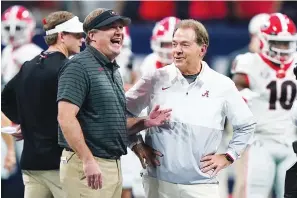  ?? The Associated Press ?? ■ Georgia head coach Kirby Smart speaks with Alabama head coach Nick Saban before the first half of the Southeaste­rn Conference championsh­ip game on Dec. 4, 2021, in Atlanta.