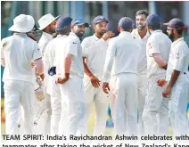  ??  ?? TEAM SPIRIT: India's Ravichandr­an Ashwin celebrates with teammates after taking the wicket of New Zealand's Kane Williamson in Kanpur on Sunday. (Reuters)