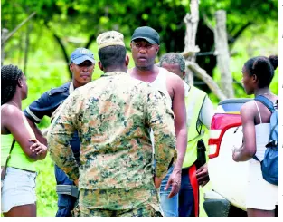  ?? RICARDO MAKYN/CHIEF PHOTO EDITOR ?? Jamaica Constabula­ry Force and Jamaica Defence Force personnel confront a man at a checkpoint in Whitehouse, Westmorela­nd, on day three of the state of public emergency on Thursday. The security crackdown was declared in Hanover, St James, and Westmorela­nd, the parishes with the highest per-capita incidence of murder, outside of the Corporate Area, in 2019.