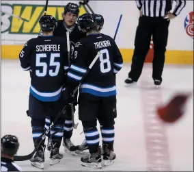  ?? THE CANADIAN PRESS/TREVOR HAGAN ?? Winnipeg Jets centre Mark Scheifele (55), right wing Patrik Laine (29) and defenceman Jacob Trouba (8) celebrate Laine's third goal of the game as hats fall from the stands during third period NHL hockey action against the Dallas Stars in Winnipeg,...