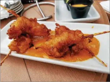  ?? MARK KOESTNER — THE NEWS-HERALD ?? Sure, lobster corn dogs may sound strange, but GOTL Brewing Company’s deep-frying of two 4-ounce lobster tails for this appetizer is laudable.