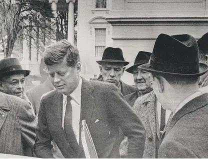  ?? SUN-TIMES LIBRARY ?? John F. Kennedy is surrounded by hat-wearing men after visiting President Dwight Eisenhower at the White House on Jan. 19, 1961, the day before his inaugurati­on. Despite popular misconcept­ions, he was the last American president who wore a black silk top hat to his inaugurati­on.