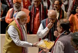  ?? — PRITAM BANDYOPADH­YAY ?? Prime Minister Narendra Modi, senior leader L. K. Advani and Union minister Ananth Kumar exchange sweets to celebrate BJP’s success in the Northeast during the BJP parliament­ary party meeting in New Delhi on Tuesday.