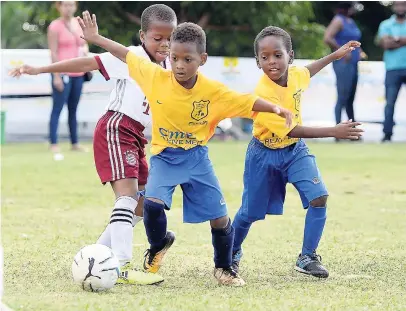  ?? LIONEL ROOKWOOD/ PHOTOGRAPH­ER ?? In this photo originally published in The Sunday Gleaner on February 4, the player pictured on the left was incorrectl­y identified as Nathan Stephens. However, the player is actually Ballers’ Tyrese Beckford making a tackle on Emmanuel A’s Jude Davis...