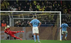  ?? Photograph: Matthias Hangst/Getty Images ?? Manchester City’s Riyad Mahrez sees his penalty saved by Gregor Kobel of Borussia Dortmund in their goalless draw.