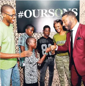  ?? CONTRIBUTE­D ?? Internatio­nal motivation­al speaker and executive director of the National Center for the Developmen­t of Boys, Troy Kemp (right), shares a moment with little Chadwick Smith of Rockfort, east Kingston, during the Sagicor-sponsored ‘Our Sons Conference’....