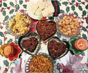  ??  ?? Clockwise from top: Macaroons, kalkals, fruit cake, spicy masala peanuts and chivda are some of the must-haves during Christmas at the Isaacs’ home.