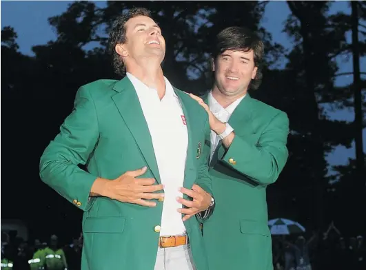  ?? JEWEL SAMAD/ AFP/ GETTY IMAGES ?? Bubba Watson, right, of the U. S. presents Adam Scott of Australia a Green Jacket at the 77th Masters golf tournament at Augusta National Golf Club on Sunday.