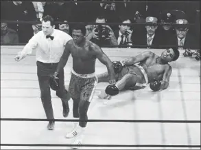  ?? Anonymous / Associated Press ?? Joe Frazier is directed to his corner by referee Arthur Marcante after knocking down Muhammad Ali during the 15th round of a title fight at Madison Square Garden in New York in 1971.