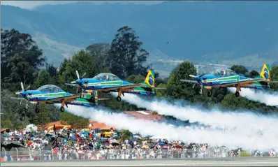  ?? FREDY BUILES / REUTERS ?? Brazilian Air Force pilots in Super Tucano planes perform aerobatics during the F-Air Colombia 2017 air festival in Rionegro, Colombia, on Saturday.