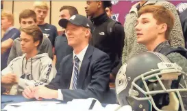  ?? Jeremy Stewart / RN-T ?? Unity Christian School senior Janson Slaughter (center) is surrounded by his teammates during an assembly at the school Thursday where he signed to play for Berry College.