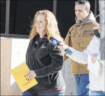  ?? Jacob Ford The Associated Press ?? Jenny Cudd, a flower shop owner and former Midland mayoral candidate, and Eliel Rosa leave the federal courthouse in Midland, Texas, on Jan. 13. Prosecutor­s have brought charges against more than 250 people in the insurrecti­on at the U.S Capitol.