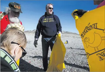  ?? Chase Stevens ?? Las Vegas Review-journal @csstevensp­hoto Interior Secretary Ryan Zinke, center, talks with Cheryl Prater, right, while joining volunteers Friday in cleaning up a shooting range area on public land along Las Vegas Boulevard just south of Sloan.