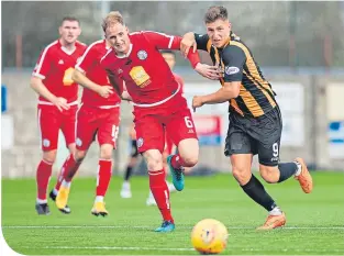  ??  ?? Brechin captain Craig Watson tries to hold off East Fife’s Andrew Jackson