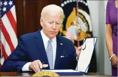  ?? Pablo Martinez Monsivais / Associated Press ?? President Joe Biden signs into law S. 2938, the Bipartisan Safer Communitie­s Act gun safety bill, in the Roosevelt Room of the White House in Washington on Saturday.