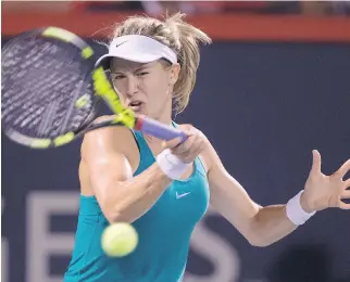  ?? PAUL CHIASSON/THE CANADIAN PRESS ?? Westmount’s Eugenie Bouchard battles Slovakia’s Kristina Kucova in Thursday night’s late match at the Rogers Cup. She lost the match and was eliminated from the tournament.