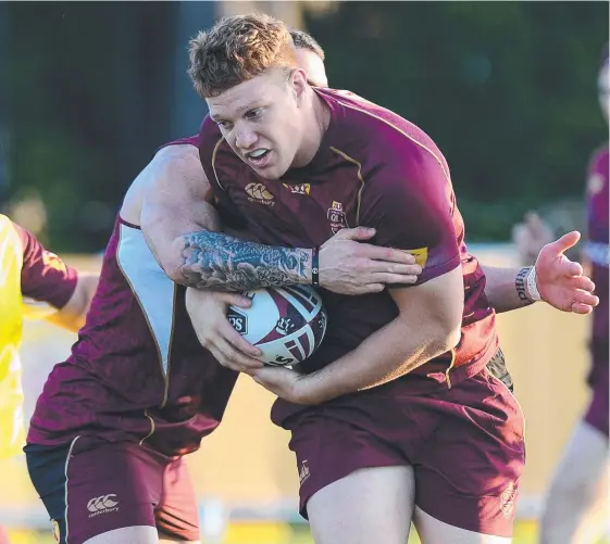  ?? Picture: GETTY IMAGES ?? Dylan Napa takes on the defence during a Maroons training session on the Gold Coast.