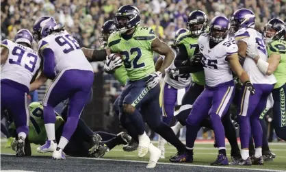  ??  ?? Chris Carson scores on a run against the Vikings during the first half. Photograph: Ted S Warren/AP